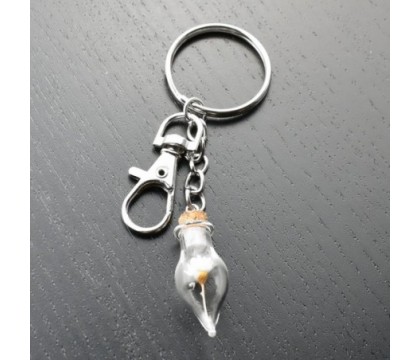 Porte-clés bijou de sac argenté fiole bouteille en verre et sa fleur jaune