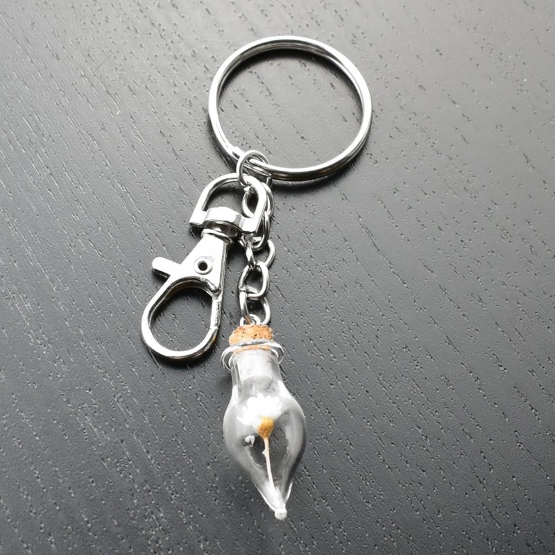 Porte-clés bijou de sac argenté fiole bouteille en verre et sa fleur jaune